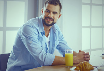 a business man breakfasts with notebook and juice