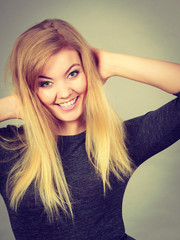 Portrait of happy blonde woman smiling with joy