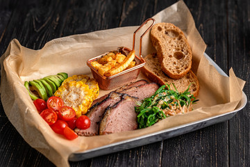 set of baked sheep and meat wooden background