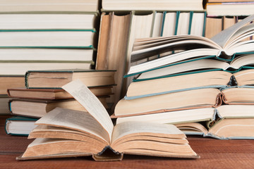 Open book on wood desk in the library room  for education background and back to school concept.
