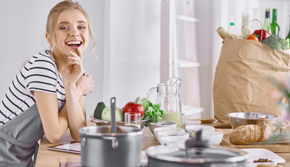 Young Woman Cooking in the kitchen. Healthy Food