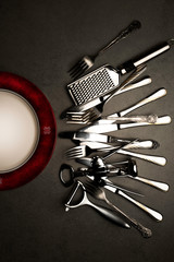 Metal cutlery on a grey stone background 