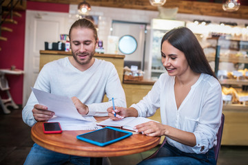 Obraz premium Young husband and wife working on business plan together