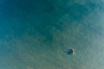 Man in Canoe in Green waters of Timor Sea 