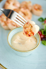 Grilled Argentine shrimp with mango-jalapeno sauce. Lunch in a restaurant, a woman eats delicious and healthy food. Delicious fresh seafood prawns with fresh vegetables and lime. Cream sauce