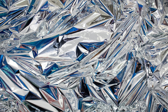 Decoration background of metal crumpled foil, shiny silver surface