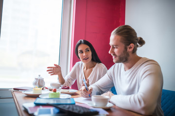 Wife and husband discussing their new menu for bakery
