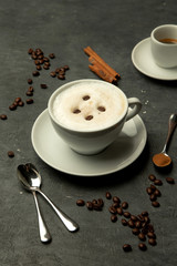 a cup of foamy latte topped with coffee beans