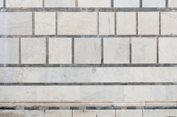 Large marble wall in the side facade of the Carrara cathedral in Tuscany.