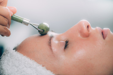 Guasha Jade Stone Roller Face Treatment in a Beauty Center