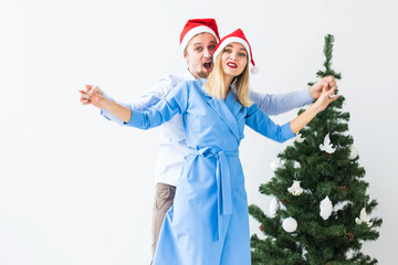 Holidays and celebration concept - Young couple celebrating Christmas at home