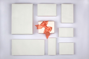 Gift boxes on white background, special gift concept. Beautiful gift box with satin ribbon and bow, color pink bronze. Square boxe. Christmas, New Year, Valentine's Day, mother's day, birthday gift.