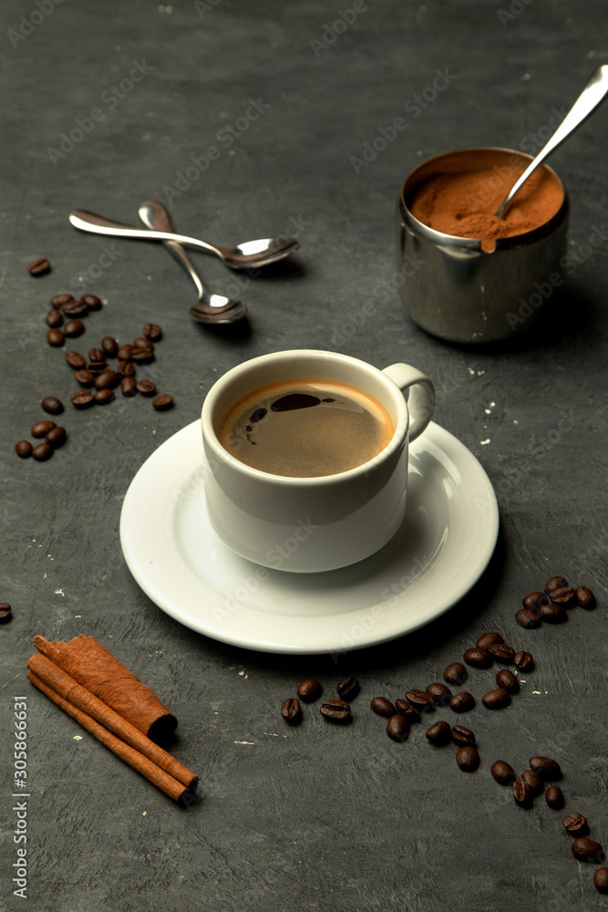 Wall mural glass of americano coffee in grey background decorated with coffee beans