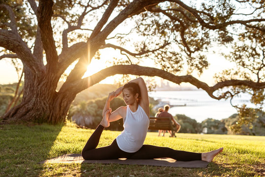 young woman doing yoga in park