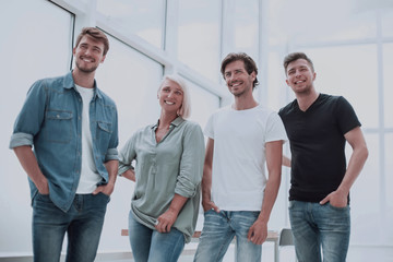 group of successful young people standing in the office
