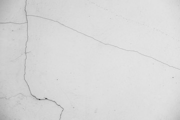 Close-up of White cement wall peeled paint caused by water and sunlight. Peel wall of White house paint with black stain. Black and White of Texture background.