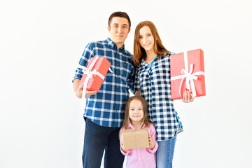 Holidays and celebration concept - Happy family with Christmas presents on white background