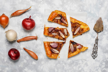 French style onion pie galette with puff pastry  and various onions shallot,red,white,yellow onions,top view