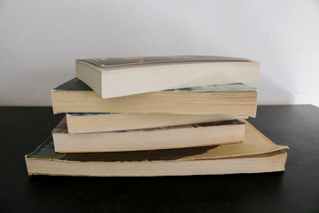 Raccolta di vecchi libri accatastati su un tavolo nero, educazione e letteratura