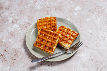 Delicious breakfast with coffee, orange juice, waffles,croissants,jam,nut paste on light background,top view