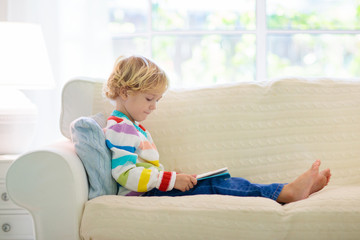 Child reading book. Kids read books.