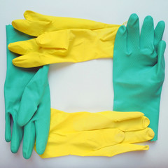 Photo of bright rubber gloves on a light background with an empty space for text. Housework and maintenance of cleanliness is the main concept of maintenance.