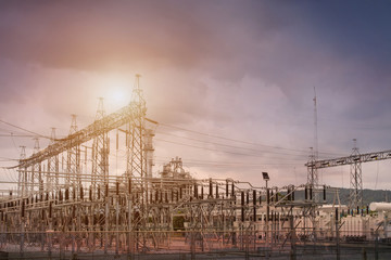 Electric factory power plant and electrical substation on a cloud sky background