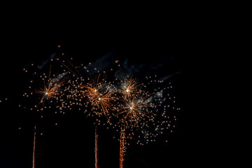 Fireworks light up on dark sky background.