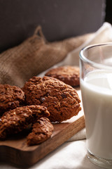 Chocolate crispy cookies with glass of milk close up