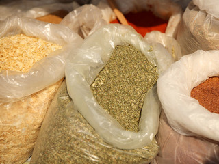 Sale of friable cereals and seasonings in open bags on a bazaar counter. Trade in cereals and...
