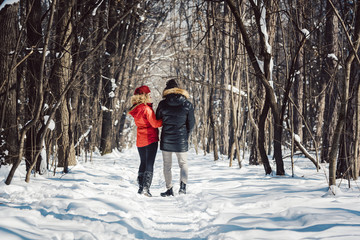 Fototapeta na wymiar Woman and man enjoying winter in the snow