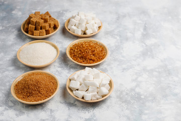 Various types of sugar, brown sugar and white on concrete background,top view