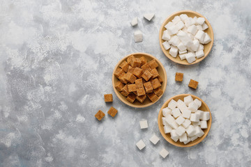 Various types of sugar, brown sugar and white on concrete background,top view