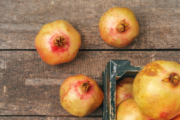 Pomegranate fruit on an old wooden background