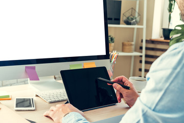 Office worker doing his job sitting at his working table with a computer