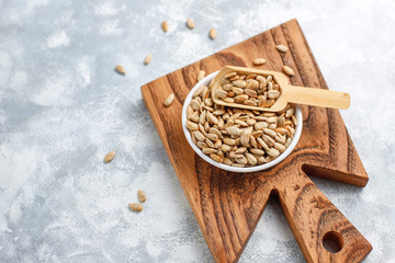Homemade sunflower halva on cutting board with sunflower seeds
