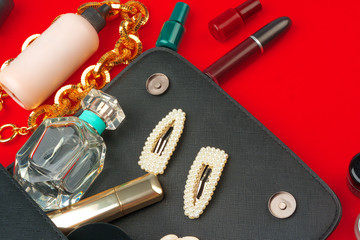 Female handbag with accessories flat lay top view