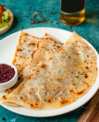 azerbaijani gutab stuffed flatbread with minced meat served with sumac