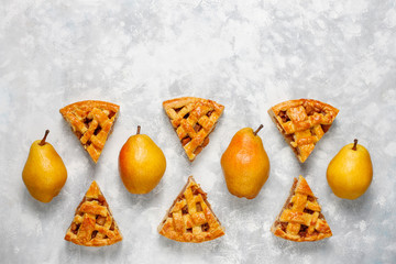 Homemade pear pie with cinnamon and walnuts on light background