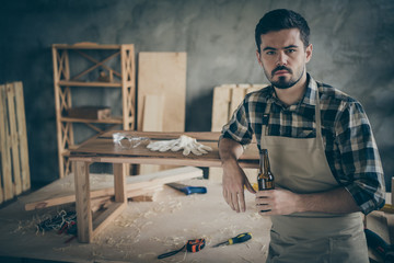 Serious successful workman hardwood entrepreneur done his slab table restoration work have rest...