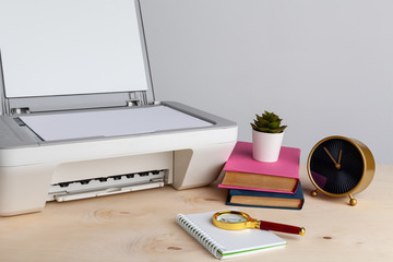 White scanner or printer machine on a table close up