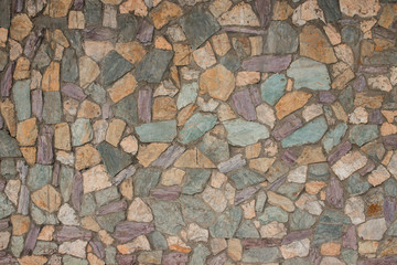 texture of stone wall. decorative stone, different colors. street tiles on the ground