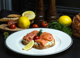 smoked salmon bruschetta with avocado in cream, and lemon