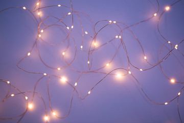 Christmas lights on dark blue background with copy space. Decorative garland