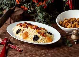 platter of traditional azerbaijani rice dish garnished with cooked dried fruits