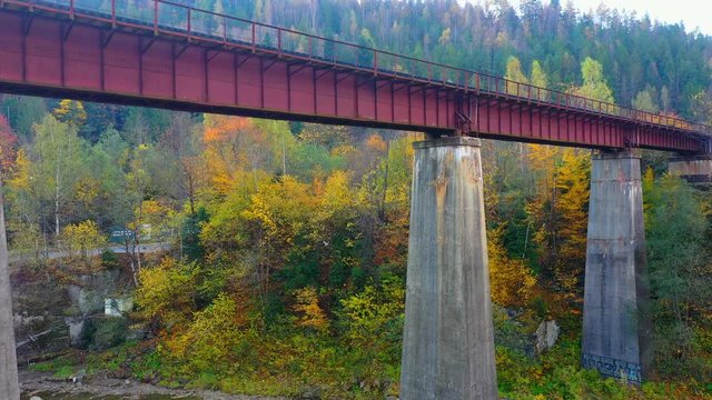 Aerial Drone video flying over railway bridge in Carpathians mountains, Yaremche, Ukraine