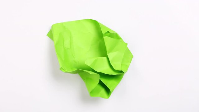Crumpled piece of green paper. Stop motion animation