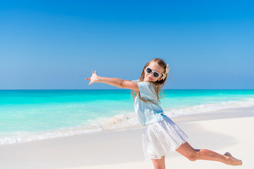 Fototapeta na wymiar Portrait of adorable little girl at beach on her summer vacation