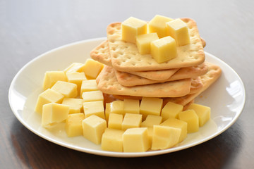 Crackers and cheese on a white plate. Selective focus.