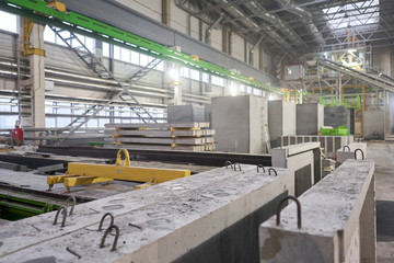 Naklejka premium Ready stairs for the house . Concrete plant. Workers in the workshop of the House-building plant. Industrial interior.